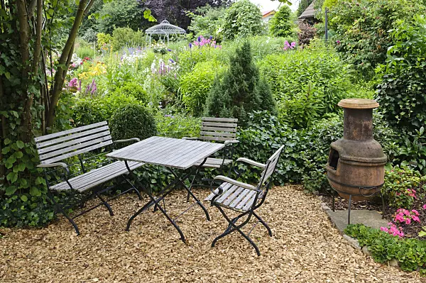 474083 - Seating area with Mexican oven in a perennial garden