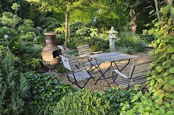 474464 - Seating area with oven in a perennial garden