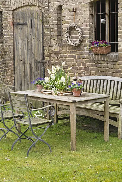 555012 - Seating area with spring decoration in front of a barn