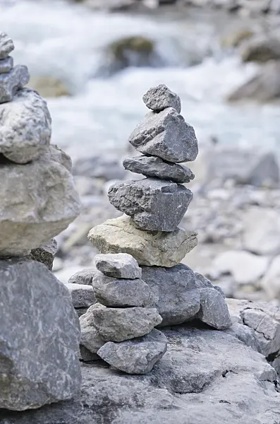 536084 - Stone pyramid at an Alpine brook