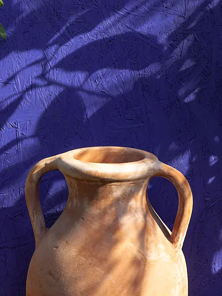 441176 - Stoneware jug in front of a blue wall