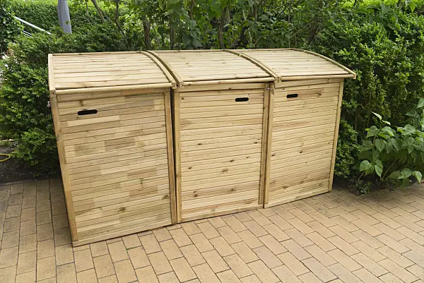 532030 - Trash bins with wooden lids on a terrace with stone tiles
