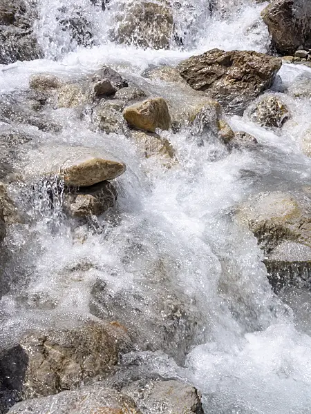 439143 - Wild foaming mountain stream crashing down between big stones