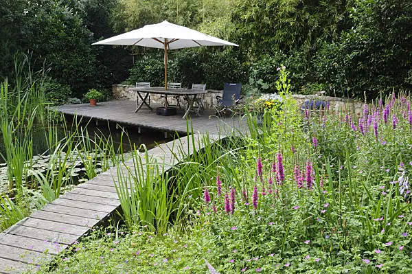 474048 - Wooden decking area with seats at a swimming pond