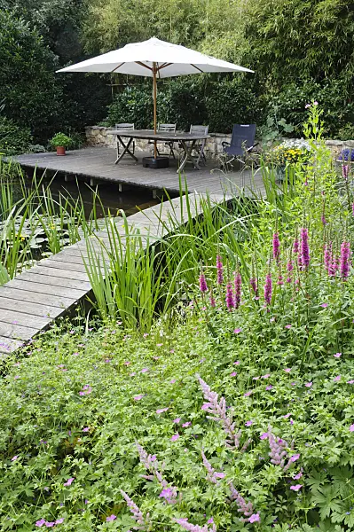 474049 - Wooden decking area with seats at a swimming pond