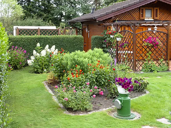 475245 - Wooden garden house and flower beds in an allotment garden