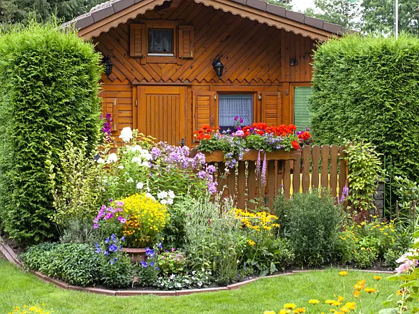 475246 - Wooden garden house and flower beds in an allotment garden