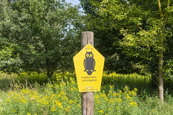 625083 - Wooden posts with signpost 'Landschaftsschutzgebiet' and owl