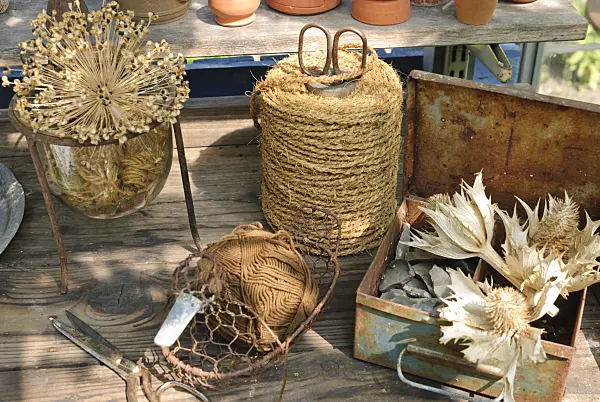 509151 - Workbench with dried flowers and rolls of binding twine